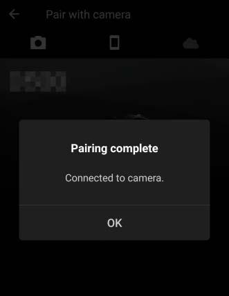 7 Kamera/iOS-laite: Seuraa näytön ohjeita. Kamera: Paina J. Kamerassa näkyy ilmoitus siitä, että laitteet on yhdistetty. ios-laite: Parinmuodostus on valmis. Kosketa OK poistuaksesi -välilehdelle.