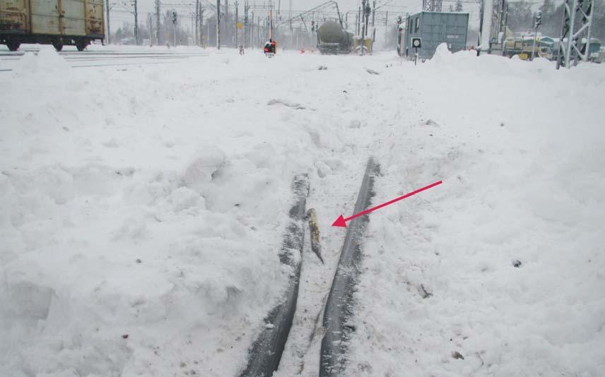 Kuva 4. Vaihteen risteyksen kiskojen välistä löytyi lumeen hautautunut pysäytyskenkä. Bild 4. Mellan rälsen i växelkorsningen hittades en bromssko som begravts i snön. Figure 4.