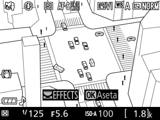 ( Miniatyyritehoste 1 Valitse reaaliaikanäkymä. Paina a-painiketta. Näkymä objektiivin läpi näytetään näytöllä.