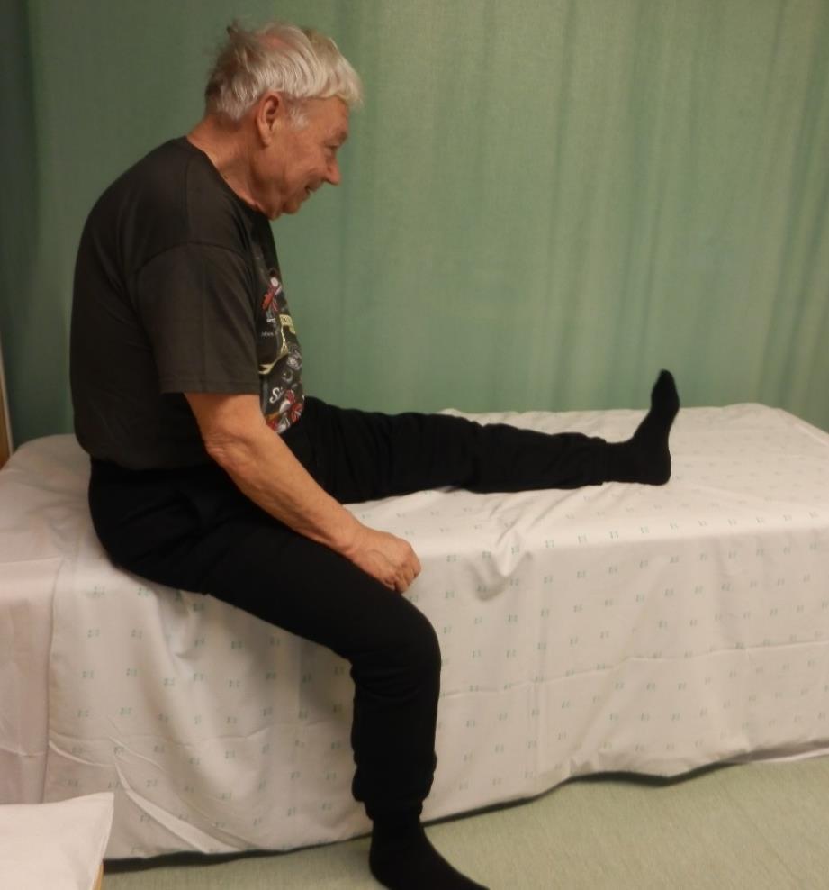 Reiden takaosan lihasten venytysliike istuen Venytettävä jalka nostetaan sängyn reunalle ja annetaan