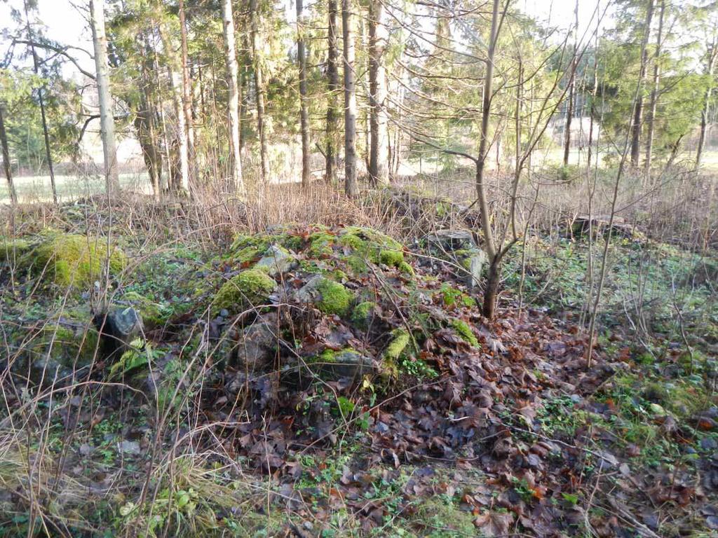 (KHH_täydennysinventointi 2013:30) Rakenne K (6805381/326164): Pituudeltaan 4 metriä, leveydeltään 1,5 metriä ja korkeudeltaan 1 metrin oleva kiviraunio.