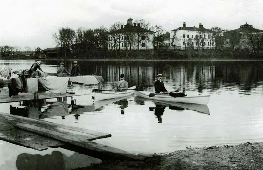 Vanajaveden rantaa Hämeenlinnassa 1890-luvulla. Taustalla näkyy silloinen lääninsairaala nykyinen Vanajveden sairaala. Oikealla on viljamakasiini (nyk Taidemuseo).