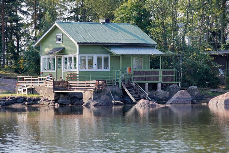 reunoilta hieman kapeampaa. 1950-luvulla rakennetun kesämökin julkisivu on muodikkaasti vaakalaudoitettu, maalina on pellavaöljymaali.