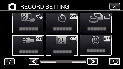 Tallennus 4 Kosketa SELF-TIMER -painiketta. Videoiden tallennus päivämäärällä ja kellonajalla Voit tallentaa päivämäärän ja kellonajan videoiden mukana.