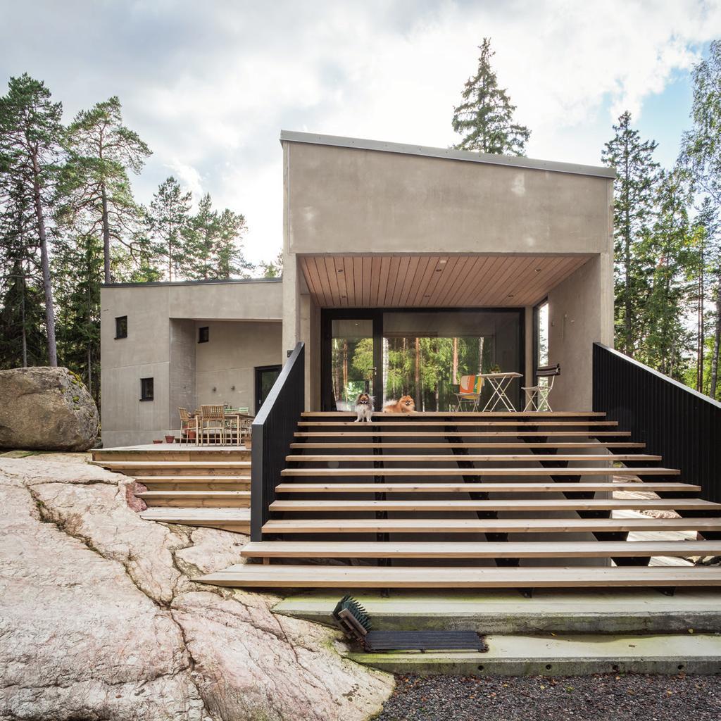 Kiven ja kallion välissä Villa K 8 8 Laaja terassi yhdistää sisätilat luonnonmaisemaan.