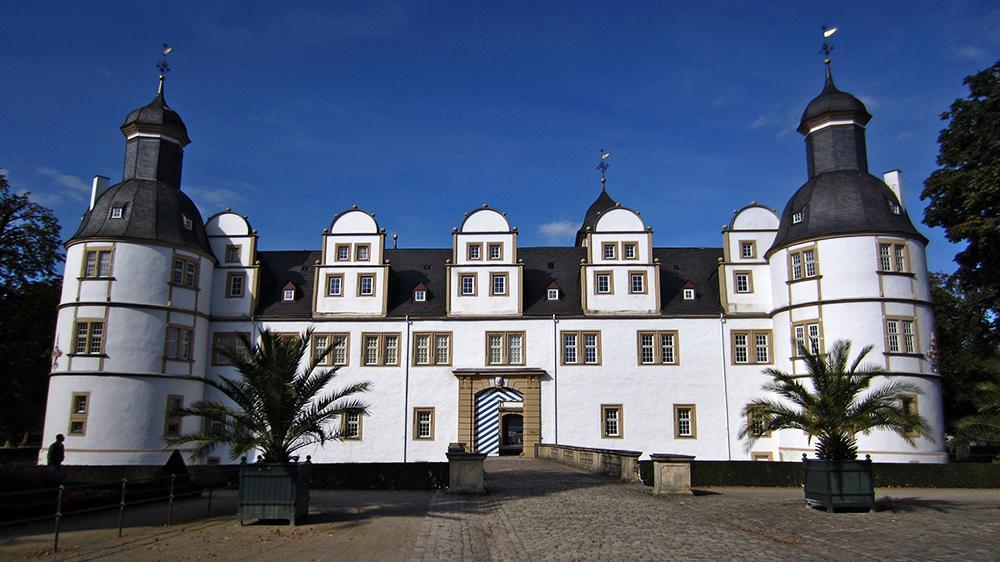 Kuva 1. Schloß Neuhaus, Paderborn. Kuva 2. Das Dreihasenfenster, Marktkirche Paderborn ja Rathaus.