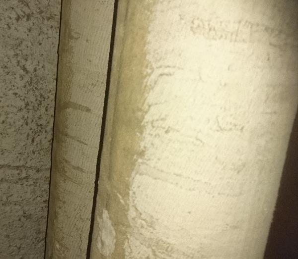 Putken pinnalla asbestipitoinen pintaharso, alla aaltopahvi ja putken
