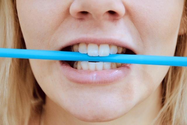 Laita pilli poikittain hampaiden väliin ja puraise kevyesti hampaat yhteen niin, että pilli jää hampaiden väliin. Vie kieli ylös ylähampaiden taakse hammasvallille.