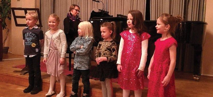 MUSIIKKI -TOIMIALA Katajanokan 6-8-vuotiaiden lauluryhmä esiintymässä joulukonsertissa 2018 opettaja Krista Pellikan johdolla Musiikkiopiston laulaja Emma Saarinen ja viulisti Heidi Simomaa.