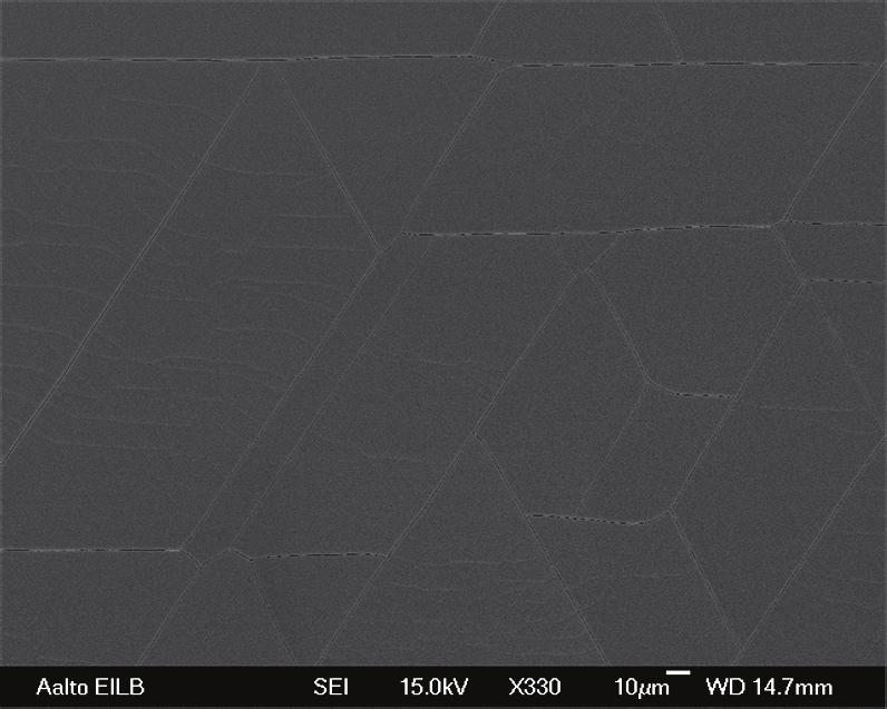 56 Figure 32: SEM micrograph of the 540 nm thick AlN film. Fractures are observed along the crystal planes. In Figure 33 the growth rate is presented as a function of growth temperature.