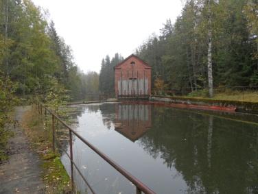 aittarakennuksia. Rakennuspaikka on peltojen keskellä näkyvänä osana kulttuurimaisema-alueella.