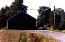 Koillisesta 16. Mutkaan sijoittuva vaalea maalaistalo pihapiireineen.
