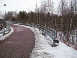 PUISTOT Keinulaudantien suojaviheralue - Skyddsgrönområde vid Gungbrädsvägen (23.) Nykytila Metroradan varressa kapea metsäkaistale.