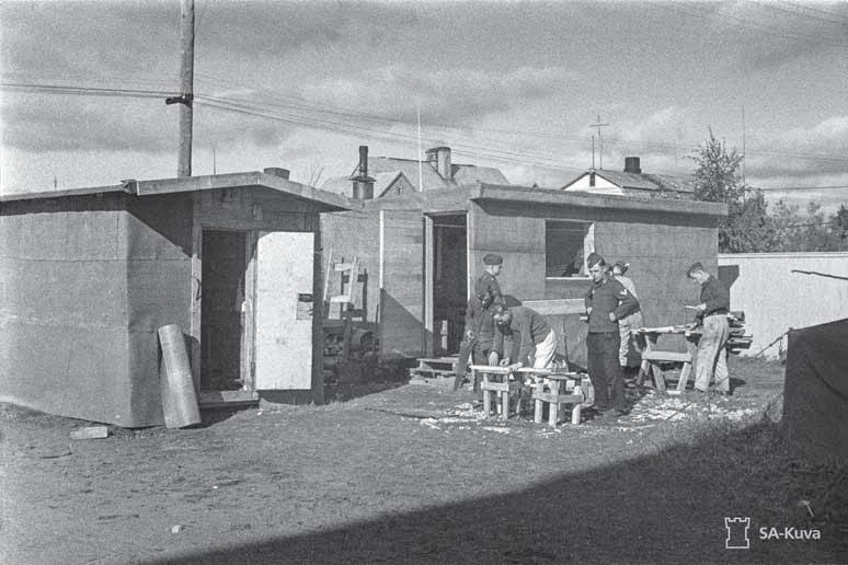 Saksalaisten ilmatorjuntamiesten parakkialue Rovaniemellä 12.9.1941. Kuva: SA-kuva. asemakaavaan piirrettyjä katuja, puistoja ja asuinalueita vielä olemassakaan muuten kuin paperilla.