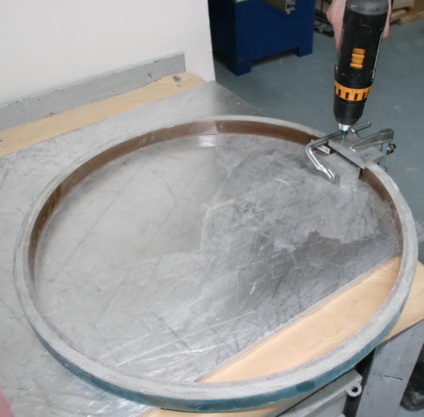 Experimental methods for determining the residual stresses of composite laminates 63 Figure 7.2. Drilling of the holes for the measurement studs. Figure 7.3. Measurement for determining the residual stress driven displacement.