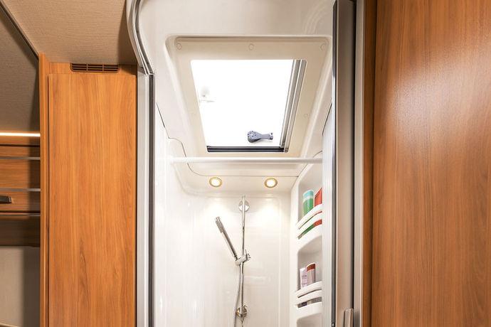 HYMER Tramp SL 704 Ambition -mallin pesutilassa on erillisen suihkun yläpuolella HYMERin maitolasinen kattoikkuna. Suihku saadaan näin hyvin tuuletettua ja samalla sinne tulee päivänvaloa.